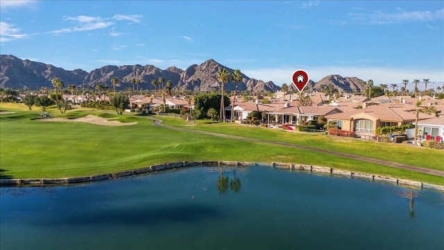 view of community featuring a lawn and a water and mountain view