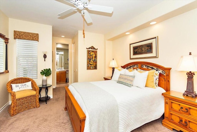 carpeted bedroom with ceiling fan and ensuite bathroom