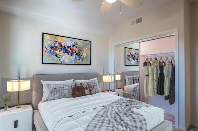 carpeted bedroom featuring a closet, visible vents, and ceiling fan