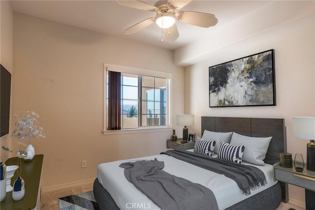 carpeted bedroom featuring ceiling fan and baseboards