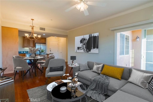 living area with dark wood-style floors, visible vents, crown molding, and ceiling fan with notable chandelier