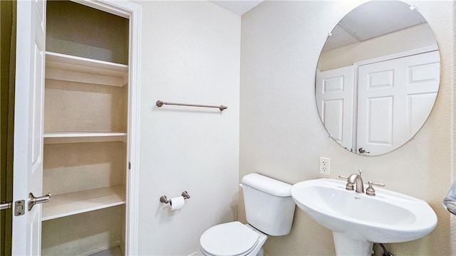 bathroom with toilet and a sink