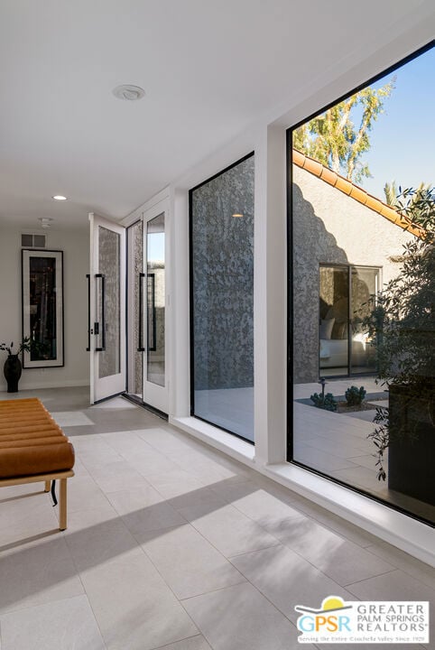 hall featuring light tile patterned floors