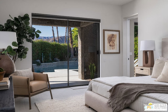 bedroom with light colored carpet, access to exterior, a mountain view, and multiple windows