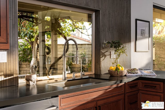 kitchen featuring dishwashing machine and sink