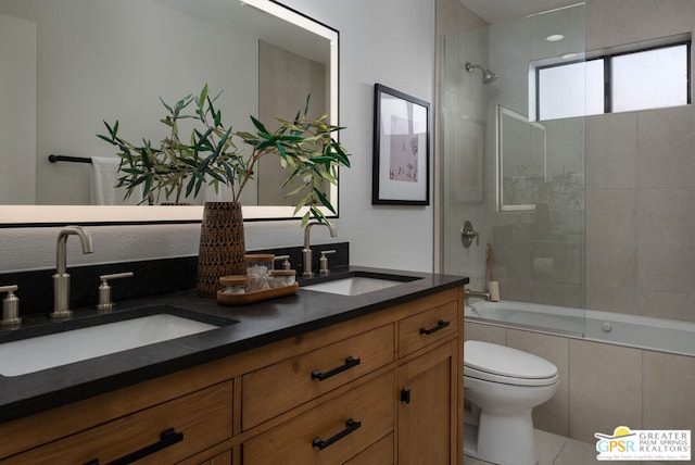 full bathroom with vanity, toilet, and tiled shower / bath