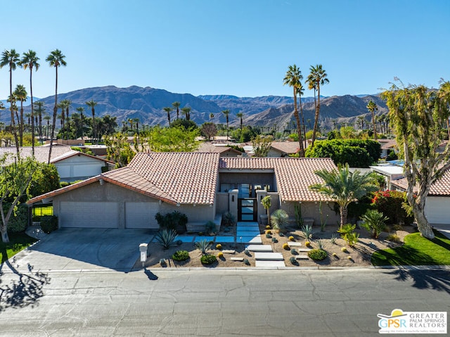 view of front of house featuring a garage and a mountain view