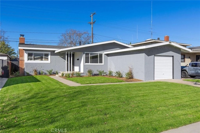 ranch-style house featuring a garage and a front lawn