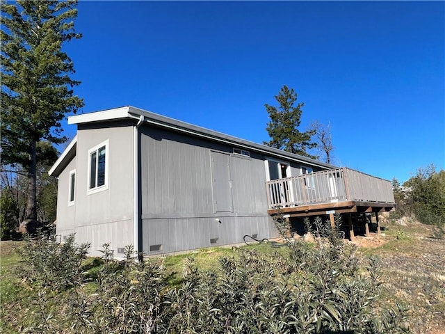 view of side of home featuring a deck