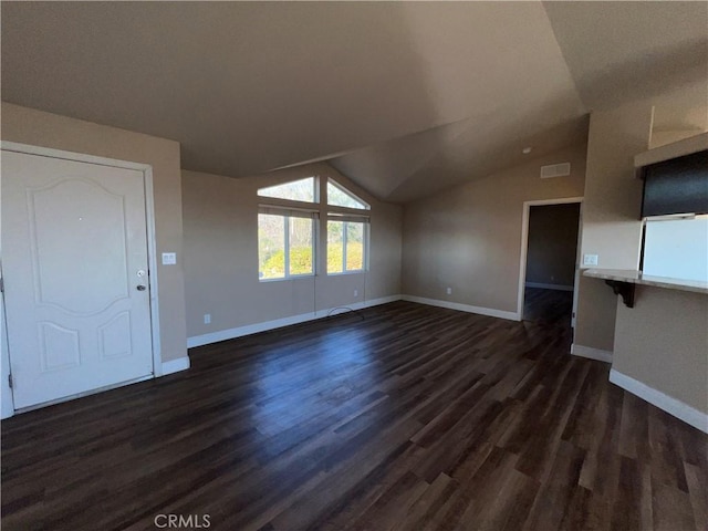 unfurnished living room featuring lofted ceiling and dark hardwood / wood-style floors