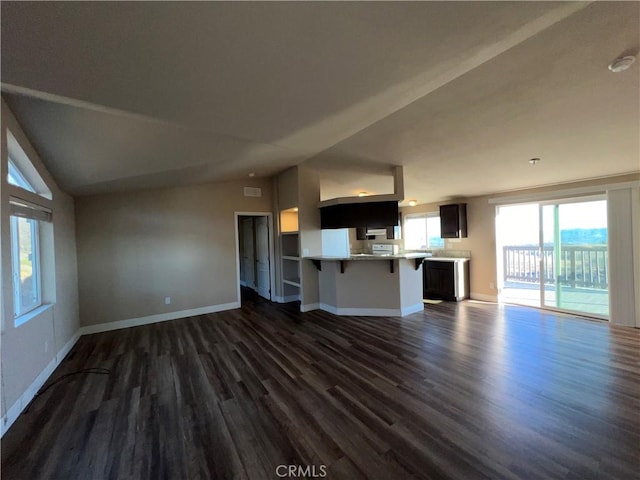 unfurnished living room with dark hardwood / wood-style floors and lofted ceiling