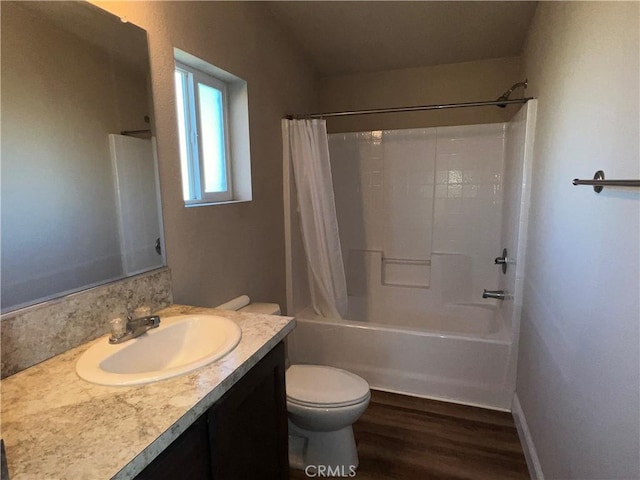 full bathroom featuring wood-type flooring, toilet, vanity, and shower / bathtub combination with curtain