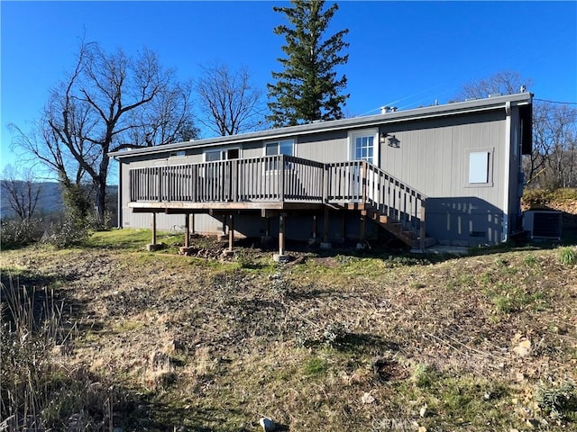 rear view of house with a wooden deck and central air condition unit