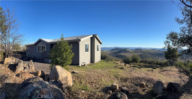 view of property exterior featuring a mountain view