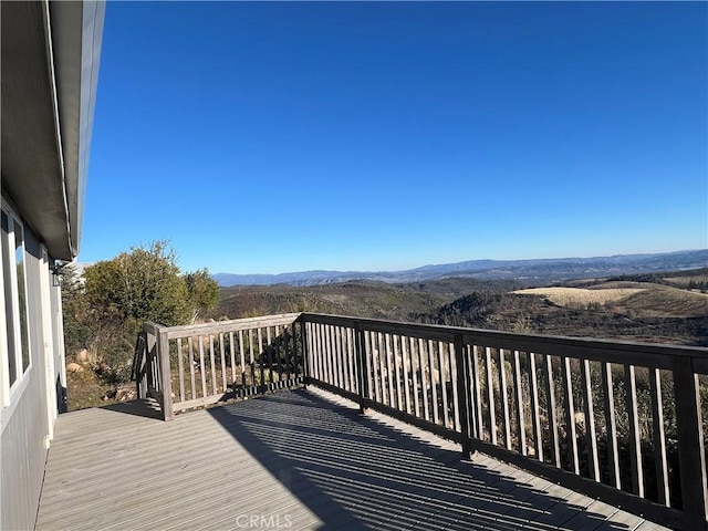 wooden deck featuring a mountain view