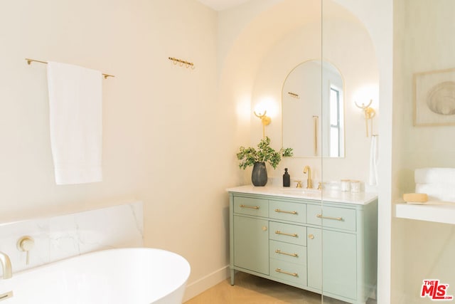 bathroom with a bath and vanity