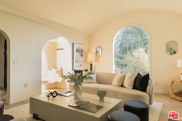 living room with light hardwood / wood-style flooring and vaulted ceiling