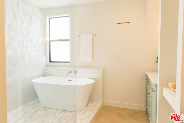 bathroom featuring a bath, parquet floors, and vanity