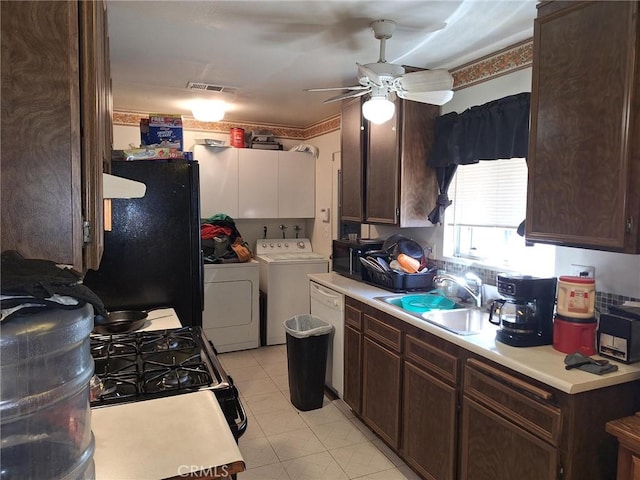 kitchen featuring light tile patterned floors, ceiling fan, washer and dryer, black appliances, and sink