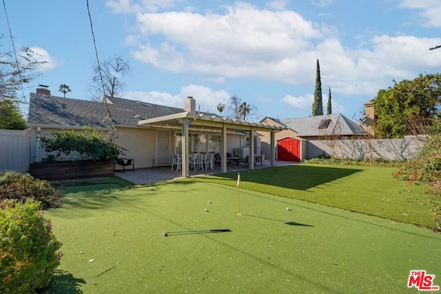 back of property featuring a patio and a storage unit