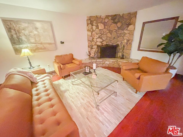 living room featuring a stone fireplace