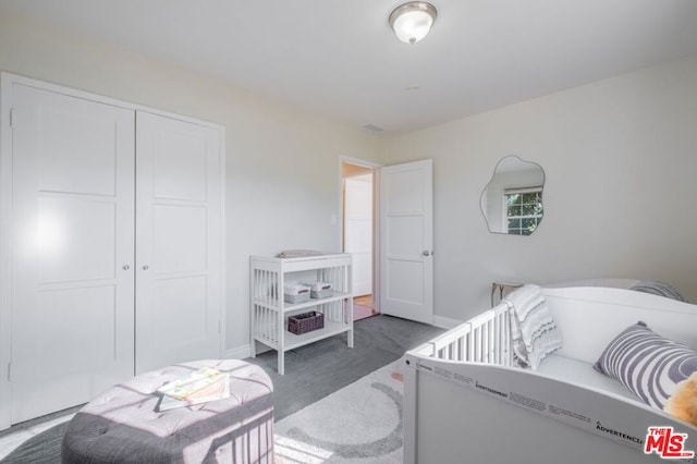 bedroom featuring dark carpet and a closet