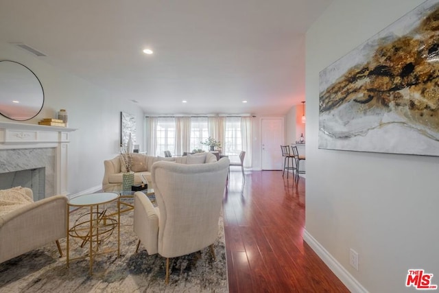 living room with a premium fireplace and dark hardwood / wood-style flooring