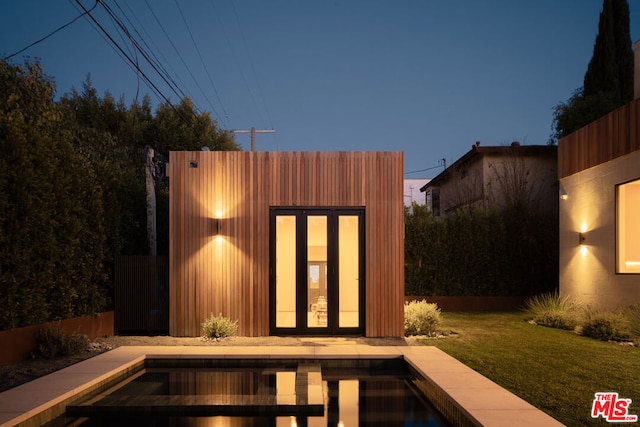 exterior space with a lawn and a fenced in pool