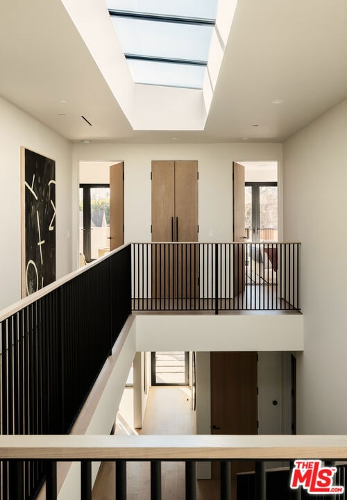 stairs featuring a skylight, a healthy amount of sunlight, and french doors