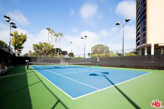 view of tennis court with basketball hoop