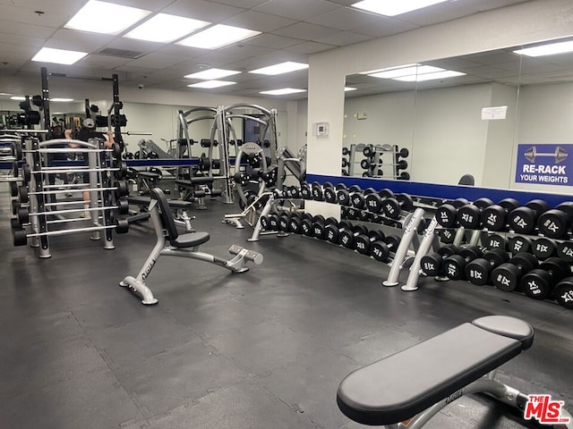 gym featuring a drop ceiling