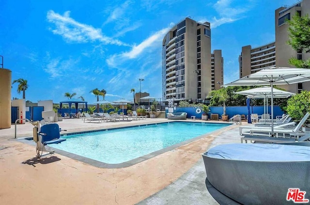 view of swimming pool with a patio area