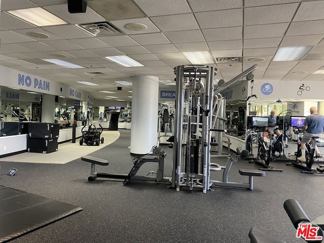 exercise room featuring a paneled ceiling