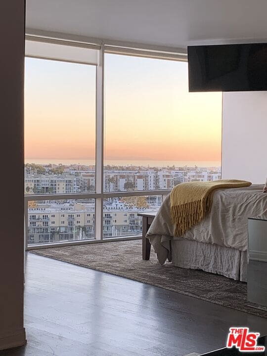 interior space featuring floor to ceiling windows and hardwood / wood-style floors