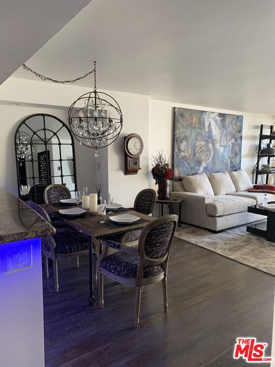 dining space featuring dark hardwood / wood-style floors and a notable chandelier