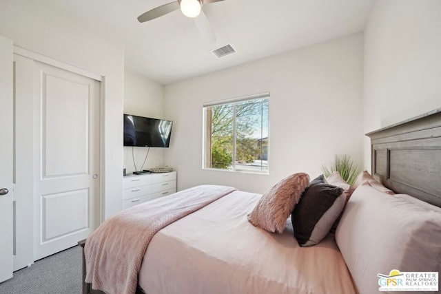 bedroom with ceiling fan, carpet, and a closet