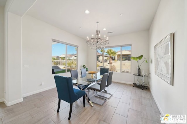 dining space featuring plenty of natural light and a chandelier