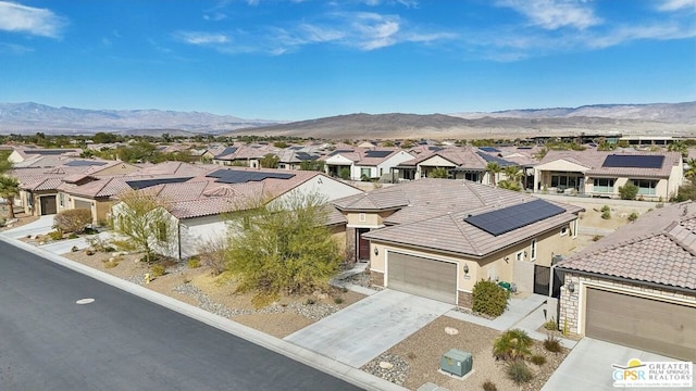 birds eye view of property with a mountain view