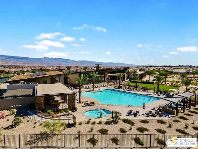 view of pool with a patio area and a mountain view