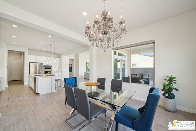 dining room with a chandelier and sink