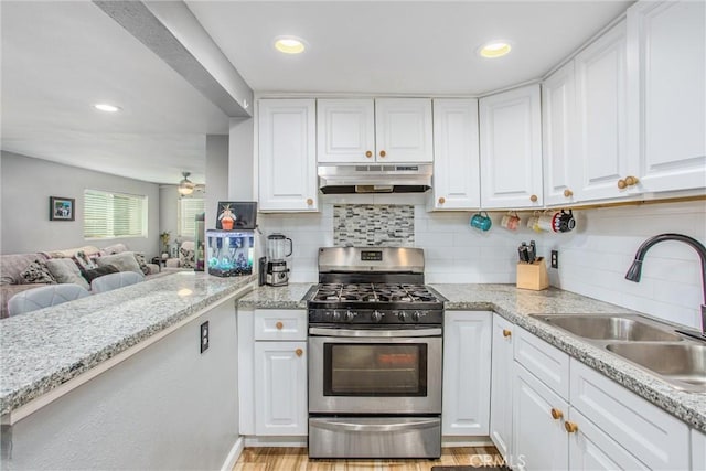 kitchen featuring sink, light wood-type flooring, white cabinetry, and stainless steel gas range