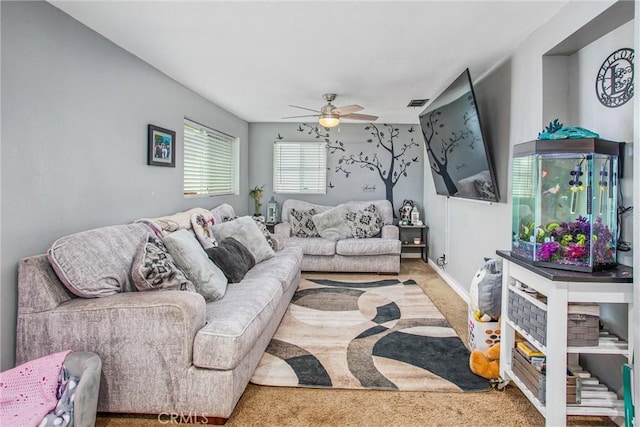 living room with ceiling fan and carpet