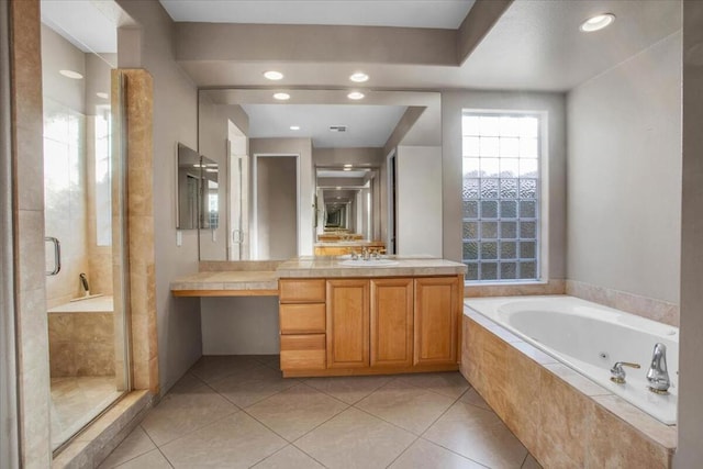 bathroom featuring tile patterned floors, vanity, and separate shower and tub