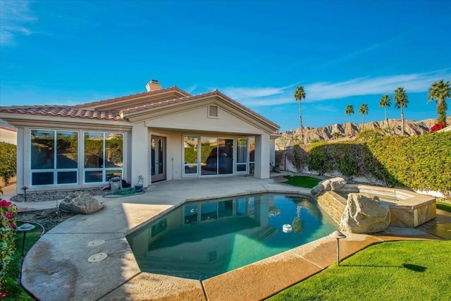 back of house with a patio