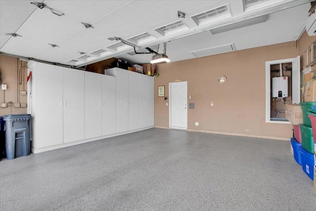 garage with a garage door opener, a wall mounted AC, and water heater