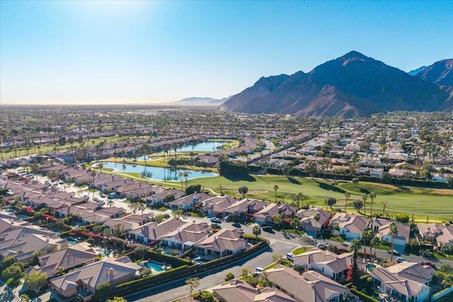 birds eye view of property with a water and mountain view