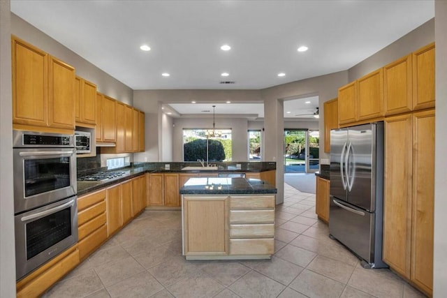 kitchen with a kitchen island, stainless steel appliances, light tile patterned flooring, decorative light fixtures, and kitchen peninsula