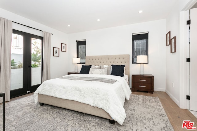 bedroom with light hardwood / wood-style flooring, french doors, and access to outside