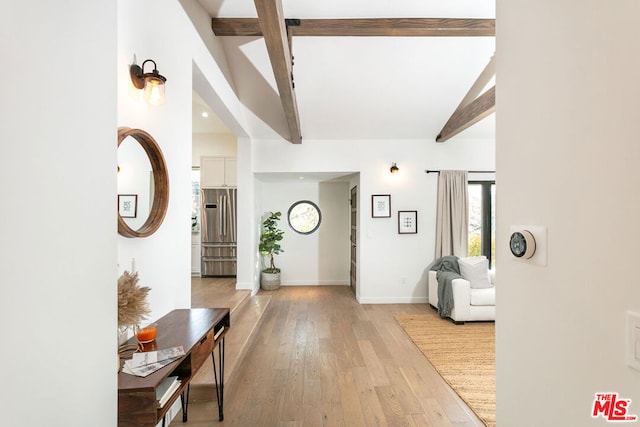 foyer featuring lofted ceiling with beams and light hardwood / wood-style floors