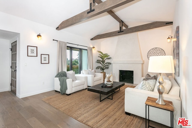 living room featuring hardwood / wood-style flooring, a large fireplace, and lofted ceiling with beams